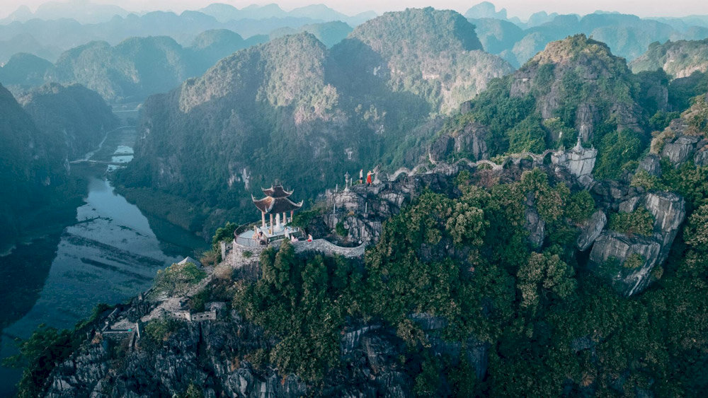 Climbing nearly 500 stone steps to Ngoa Long Mountain for a breathtaking panoramic view of Tam Coc